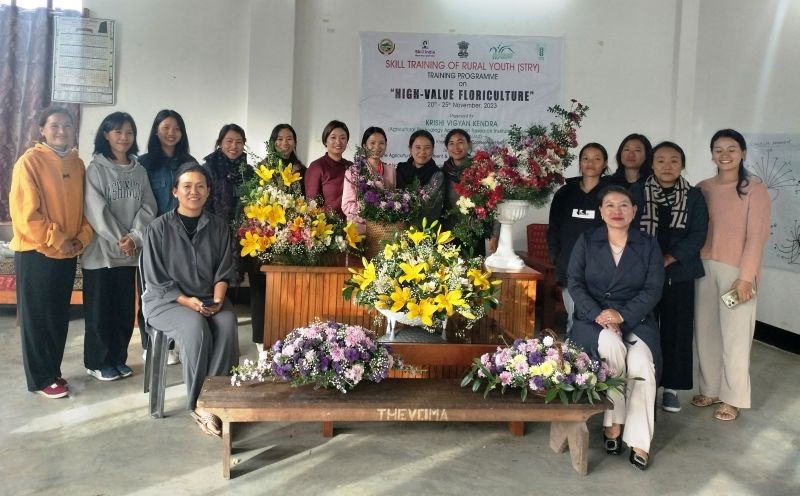 Resource persons and participants with various types of flower arrangements.